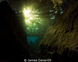 Sunset under the Jetty at Wakatobi. Golden rays came down... by James Deverich 
